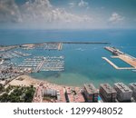 Aerial photo of harbour Naufragos Acequion, residential houses, highways and Mediterranean Sea of Torrevieja. High angle view famous popular travel destination. Costa Blanca. Alicante province. Spain.