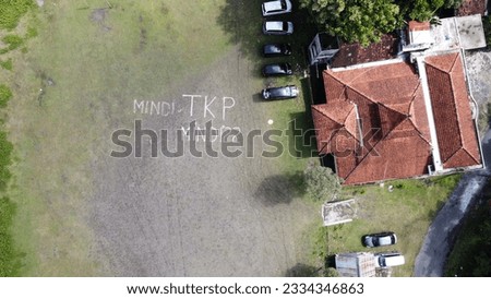 Aerial photo of a line of cars in a field in Mindi, Klaten, Central Java, Indonesia.