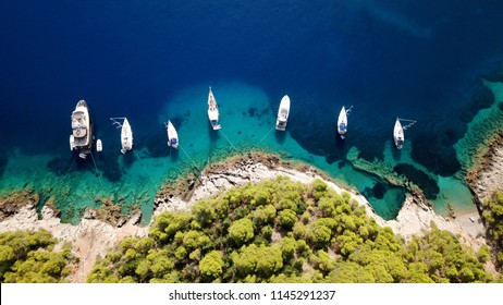 Aerial photo of luxury sail boat docked in tropical caribbean rocky turquoise color seascape