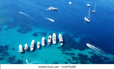 Aerial photo of luxury yachts docked in tropical caribbean island with emerald clear sea