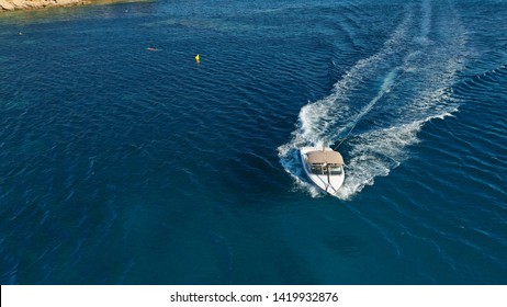 Aerial Photo Of Man Practicing High Speed Water Ski Towed By Speed Boat In Deep Blue Sea