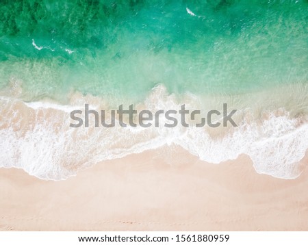 Similar – Luftaufnahme Panoramadrohne Blick auf den blauen Ozean Wellen, die am Sandstrand in Portugal erdrücken.