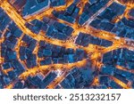 Aerial photo of an old neighborhood of city of Istanbul at night brightly lit featuring intricate street patterns and illuminated streets between historic buildings.