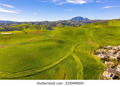 Aerial photo over Antioch, California with beautiful bright green hills and a blue sky and Mt.Diablo in the background.