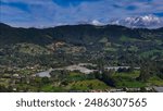 Aerial photo over the rural area of ​​the municipality of La Ceja, Antioquia, Colombia. You can enjoy the beautiful contrast between the green of its mountains and the blue sky.