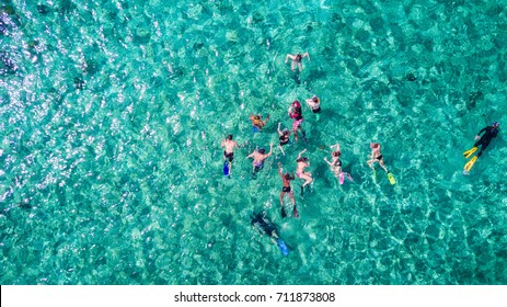 Aerial Photo Of People Snorkeling In Tropical Waters In Belize