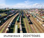 Aerial photo of railway terminal. Freight wagons with goods on railroad station. Cargo transportation. Import and export logistics. Industrial landscape. Top view from drone. Heavy industry.