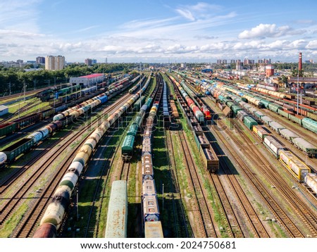 Aerial photo of railway terminal. Freight wagons with goods on railroad station. Cargo transportation. Import and export logistics. Industrial landscape. Top view from drone. Heavy industry.