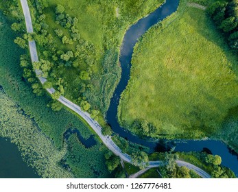 Aerial Photo of Road going by the River under the Trees, Top Down View in Early Spring on Sunny Day - Concept of Peaceful Life in Countryside in Harmony - Shutterstock ID 1267776481
