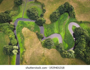 aerial photo of small river meandring through green fields