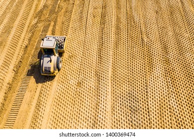 Aerial Photo Of A Steam Roller And A Backhoe On A Roadwork