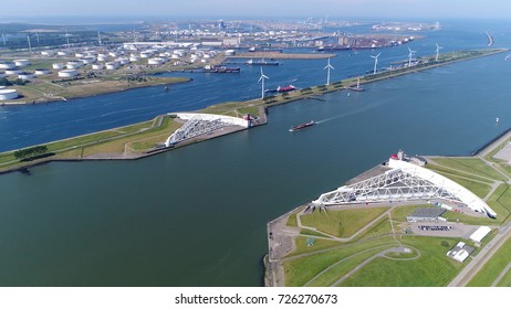 Aerial photo storm surge barrier showing Maeslantkering and Rotterdam industry the construction of Maeslantkering was part of Europoortkering project which was final stage of Delta Works 
