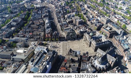 Aerial photo taken from helicopter of Amsterdam city center Dam Square also showing national monument the Royal Palace and the New Church popular tourist attraction in the Netherlands
