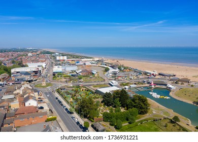 Aerial photo of the town centre of Skegness showing the pier on the sandy beach near fairground rides in the East Lindsey district of Lincolnshire, England on a beautiful sunny summers day.