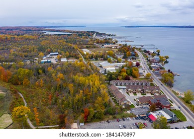 Aerial Photo Of Traverse City Michigan During The Fall. Autumn Colors Fill The Trees Creating A Beautiful, Colorful Landscape. 