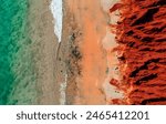 Aerial Photo of turquoise ocean water and red rock cliffs, James Price Point, Kimberley Region, Broome Western Australia