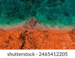 Aerial Photo of turquoise ocean water and red rock cliffs, James Price Point, Kimberley Region, Broome Western Australia