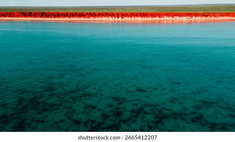 Aerial Photo of turquoise ocean water and red rock cliffs, James Price Point, Kimberley Region, Broome Western Australia - Powered by Shutterstock