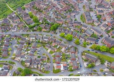 Aerial photo of a typical British housing estate in the village of Middleton in Leeds West Yorkshire in the UK, showing a top down drone view of suburban streets, roads and rows of houses.