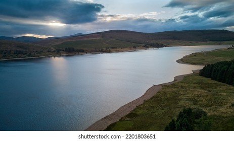 Aerial Photo Of Water Reservoir In Evening Under Colorful Sky