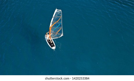 Aerial photo of woman wind surfer cruising in Mediterranean destination bay with deep blue - Shutterstock ID 1420253384