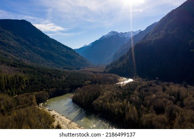 An Aerial Photograph Of A River Moving Through A Valley In The Pacific Northwest