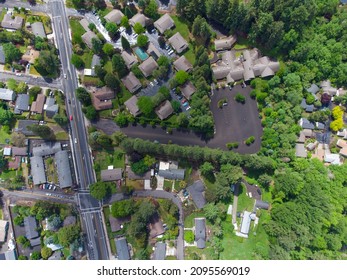 Aerial Photograph. Small Green Town Near The Forest. Small Houses, Paved Roads. Abstraction. There Are No People In The Photo. Forestry, Forestry, Housing, Real Estate, Tourism.