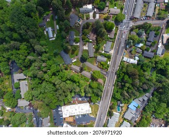 Aerial Photograph. A Small Town Surrounded By Greenery. Roofs Of Small Houses, Asphalt Roads, A Large Road. There Are No People In The Photo. Advertising Of Tourist Destinations, Ecology.