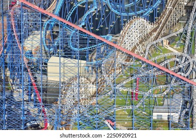 An aerial photograph taken from a helicopter of the rollercoasters at Blackpool Pleasure Beach, Northern England, United Kingdom. Colourful looping amusement rides at a seaside theme park.