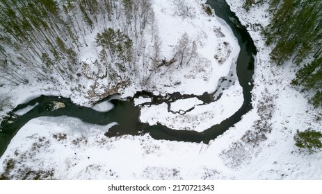 Aerial Photography From Above, Turn Of The Winter River. Forest On The Banks And Snow