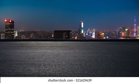 Aerial photography bird view at Empty road floor surface with city landmark buildings background at Shanghai bund panorama Skyline of night scene