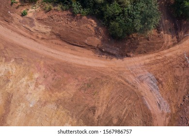 Aerial photography dirt road curved road texture and trees top view - Powered by Shutterstock