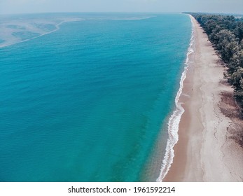 Aerial Photography Of A Drone From A Bird's-eye View. Kata Beach On The Island. The Turquoise Ocean Washes The Bright Sandy Shore With Waves. Many Green Trees Stand On The Coast.