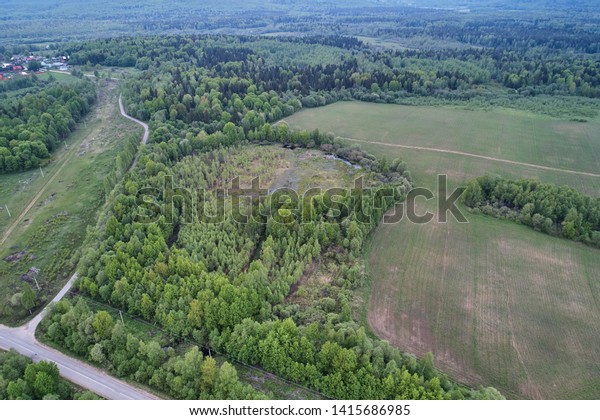 Aerial photography with a drone. Landscape with a\
road and a field