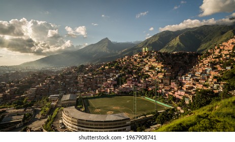 Aerial photography of the Palo Verde baseball stadium, in Caracas, with the Petare slum in the background and the Avila mountain further back, during a beautiful sunset