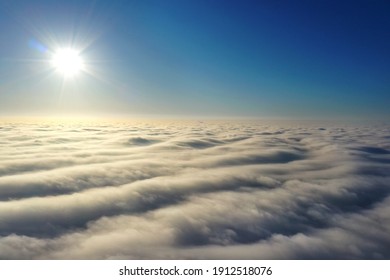 Aerial Photography, Rays Of Bright Sunlight Falling On Wavy Gray Clouds. A Photograph About 500 Meters High, Taken From A Height By A Latest Generation Drone.