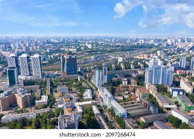 Aerial photography of residential areas of the city overlooking the new skyscrapers, aerial view, photographing the city against the backdrop of the smoky skyline and blue sky. Copy space.