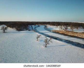 Aerial Photography Of A Rural Bridge Spanning The Frozen Red River Between Minnesota And North Dakota.