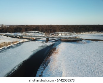 Aerial Photography Of A Rural Bridge Spanning The Frozen Red River Between Minnesota And North Dakota.