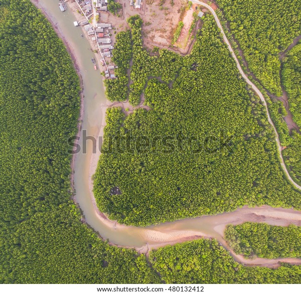 aerial photography a small\
fishing village name BanSamchong  in Phang Nga province cover by\
pine forest in front of village have pier for transport to Andaman\
sea. 