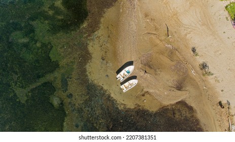 Aerial Photography Of A Two Wooden Boats On The Sandy Beach