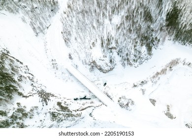 Aerial Photography Winter Landscape Of River And Forest Area, Rocky Shores And Frozen River. A Lot Of Snow In The Forest Area