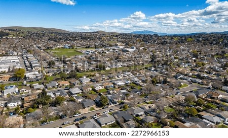 Aerial Photos over a community in Vallejo, California with houses, streets, cars and parks