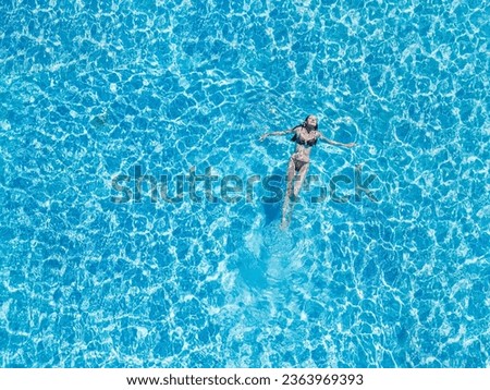 Aerial photos of woman swimming in the pool