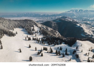 Aerial of Piatra Craiului National Park, near Piatra Mica or Cabana Curmatura. Piatra Craiului mountains are a mountain range in the Southern Carpathians. Bucegi Mountains on background