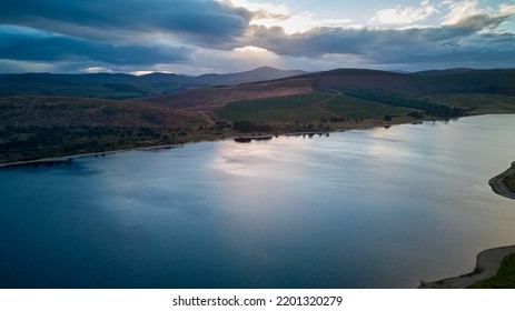 Aerial Picture Of A Water Reservoir And Remote Mountains At Twilight