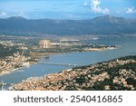 Aerial pilot cockpit view of airport runway and Croatian town city of Split with islands and sea