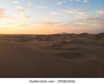 Aerial postcard panorama sunset view of isolated vast dry sand dunes desert of Huacachina Ica Peru South America - Powered by Shutterstock