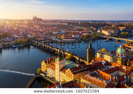 Aerial Prague panoramic drone view of the city of Prague at the Old Town Square, Czechia. Prague Old Town pier architecture and Charles Bridge over Vltava river in Prague at sunset, Czech Republic. 