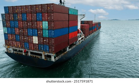 Aerial rear view Container Ship load container going to seaport or unload at container warehouse on the green sea. Logistics, import export, shipping or transportation Asia Pacific and worldwide.